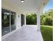 Covered back patio with marble-like tile and sliding doors at 118 Green Pine Park, Rotonda West, FL 33947