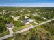 Aerial view of a house and its surrounding neighborhood, showing the property's setting at 118 Green Pine Park, Rotonda West, FL 33947