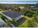 Aerial view of a house's back, highlighting its patio and surrounding landscape at 118 Green Pine Park, Rotonda West, FL 33947