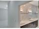 Elegant bathroom with marble tile, double vanity, and modern fixtures at 118 Green Pine Park, Rotonda West, FL 33947