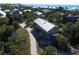 Aerial view of an elevated beach house and surrounding neighborhood at 8934 Gulf St, Placida, FL 33946
