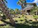 Elevated home with covered porch and tropical landscaping at 8934 Gulf St, Placida, FL 33946