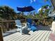 Relaxing deck with Adirondack chairs and umbrella at 8934 Gulf St, Placida, FL 33946