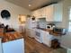 Modern kitchen with white cabinets and wood countertops at 8934 Gulf St, Placida, FL 33946
