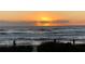 Stunning sunrise over the ocean with beachgoers enjoying the morning at 8934 Gulf St, Placida, FL 33946