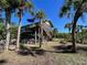 Elevated home with a deck, tropical landscaping and fenced yard at 8934 Gulf St, Placida, FL 33946