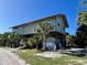 Elevated home with a covered porch and tropical landscaping at 8934 Gulf St, Placida, FL 33946