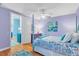 Lavender bedroom with a full-size bed and colorful decor at 10470 Sunny Dreams Ter, Placida, FL 33946