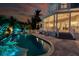 Relaxing pool area with lighting and seating at sunset at 10470 Sunny Dreams Ter, Placida, FL 33946