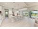 Open kitchen with white cabinets, island, and stainless steel appliances at 777 Boundary Blvd, Rotonda West, FL 33947