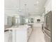 Open concept kitchen boasts white cabinets, stainless steel appliances, and an expansive island at 777 Boundary Blvd, Rotonda West, FL 33947