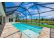 Stunning screened-in pool with a spacious deck, offering privacy and water views at 777 Boundary Blvd, Rotonda West, FL 33947