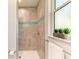 Spa-like shower with tile surround and accent mosaic at 779 Boundary Blvd, Rotonda West, FL 33947