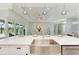 Modern kitchen with island, stainless steel sink and view of living room at 779 Boundary Blvd, Rotonda West, FL 33947