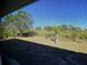 View of backyard through screen, lush landscaping at 6 Transon Ln, Placida, FL 33946