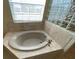 Bathroom with soaking tub, tile surround, and large window at 6 Transon Ln, Placida, FL 33946