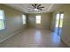 Large bedroom with ceiling fan and sliding glass doors to patio at 6 Transon Ln, Placida, FL 33946