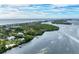 Aerial view of coastline, ocean, and waterfront home at 10470 Sunny Dreams Ter, Placida, FL 33946