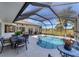 Covered patio area overlooking the pool and canal at 15390 Ancel Cir, Port Charlotte, FL 33981