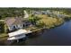 Aerial view showcasing canal-front home with boat lift at 15390 Ancel Cir, Port Charlotte, FL 33981