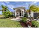 Landscaped front yard with lush greenery and a welcoming entrance at 15390 Ancel Cir, Port Charlotte, FL 33981