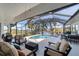 Relaxing screened pool and patio area with comfortable seating at 15390 Ancel Cir, Port Charlotte, FL 33981