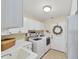 Laundry room with washer, dryer, cabinets, and a sink at 15390 Ancel Cir, Port Charlotte, FL 33981