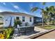 Outdoor patio with seating area, overlooking canal. Kayaks are stored nearby at 15390 Ancel Cir, Port Charlotte, FL 33981