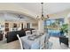 Bright dining room with table, chairs, and view of pool at 15390 Ancel Cir, Port Charlotte, FL 33981
