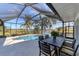 Screened patio with pool and canal view at 15390 Ancel Cir, Port Charlotte, FL 33981