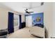 Bright bedroom with a white bed frame, blue bedding, and a ceiling fan at 15390 Ancel Cir, Port Charlotte, FL 33981