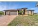 One story house with three-car garage and lush landscaping at 9303 Migue Cir, Port Charlotte, FL 33981