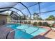 Inviting screened pool and patio area, perfect for relaxation and outdoor entertaining at 9303 Migue Cir, Port Charlotte, FL 33981
