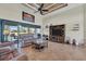 Living room with sectional sofa, large TV, and access to the kitchen and backyard at 9303 Migue Cir, Port Charlotte, FL 33981