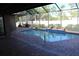 Relaxing kidney-shaped pool with brick pavers and screened enclosure at 9303 Migue Cir, Port Charlotte, FL 33981