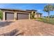 One story house with three-car garage and paver driveway at 9303 Migue Cir, Port Charlotte, FL 33981