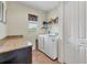 Bright laundry room featuring washer, dryer, and extra storage at 9303 Migue Cir, Port Charlotte, FL 33981