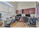 Home office with two workstations, ample cabinet space, and a large window at 9303 Migue Cir, Port Charlotte, FL 33981