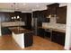 Spacious kitchen with dark cabinetry, granite countertops, and stainless steel appliances at 9303 Migue Cir, Port Charlotte, FL 33981