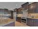 Modern kitchen with stainless steel appliances and granite countertops at 9303 Migue Cir, Port Charlotte, FL 33981