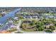 Aerial view of a residential area showcasing waterfront properties and lush landscaping at 9303 Migue Cir, Port Charlotte, FL 33981