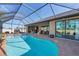 Relaxing screened pool area with brick pavers and seating at 9303 Migue Cir, Port Charlotte, FL 33981