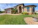 One-story home with a large front yard, two-car garage, and attractive landscaping at 9303 Migue Cir, Port Charlotte, FL 33981