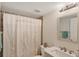 Updated bathroom featuring tile floors, modern vanity, and decorative shower curtain at 175 Kings Hwy # 1014, Punta Gorda, FL 33983