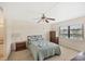 Cozy bedroom with a ceiling fan and view of the lake from the window at 175 Kings Hwy # 1014, Punta Gorda, FL 33983