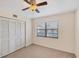 Bedroom featuring a ceiling fan, window with blinds, and double door closet at 175 Kings Hwy # 1014, Punta Gorda, FL 33983
