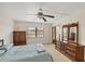 Well-lit bedroom features ceiling fan and view of the lake from the window at 175 Kings Hwy # 1014, Punta Gorda, FL 33983