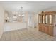 Open-concept dining and kitchen area with tile flooring and a large wooden hutch at 175 Kings Hwy # 1014, Punta Gorda, FL 33983