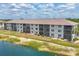 Condominium building with lakeside views and enclosed lanais at 175 Kings Hwy # 1014, Punta Gorda, FL 33983