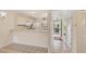 Bright kitchen features tiled floors, white cabinets, and access to the entryway at 175 Kings Hwy # 1014, Punta Gorda, FL 33983
